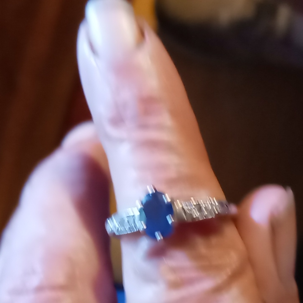 Dark blue sapphire ring set with diamonds on white gold